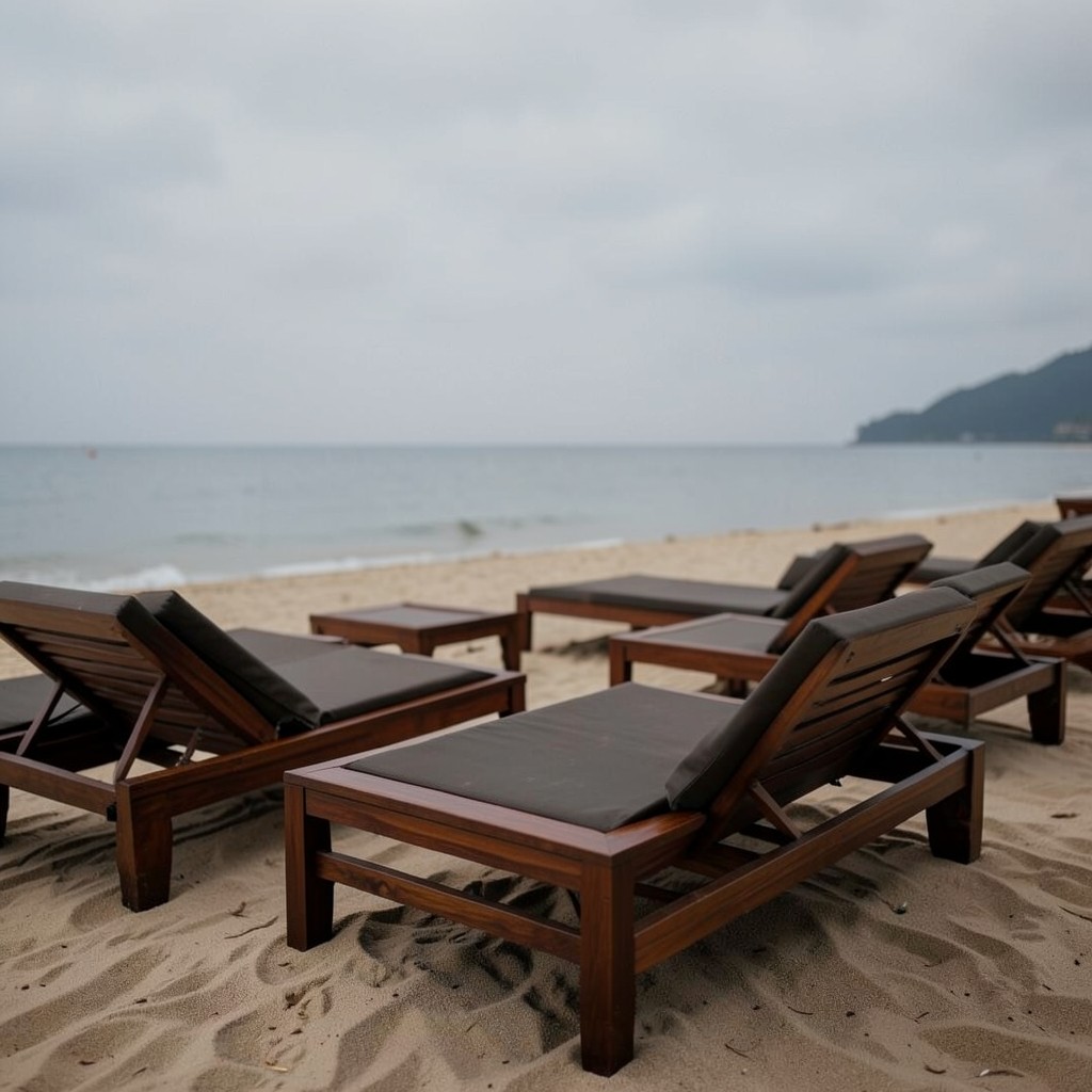 Empty beach lounge area under monsoon-season cloudy sky